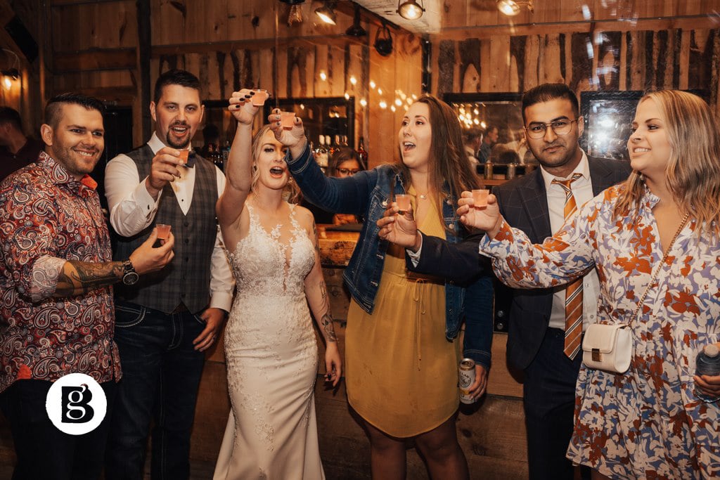 People toasting at The Barn at Lions Garden Estate. How to write the best best man speech.